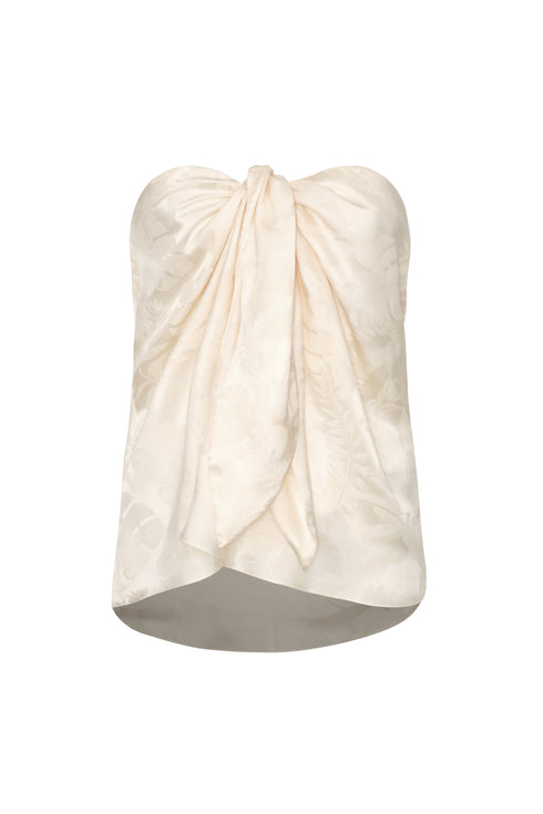Ivory silk jacquard strapless blouse with a front-tie sarong-style drape and rainforest pattern.